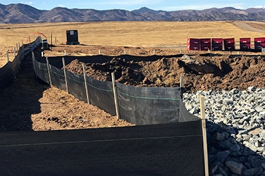 How does the silt fence with wooden stake work for the erosion control projects?